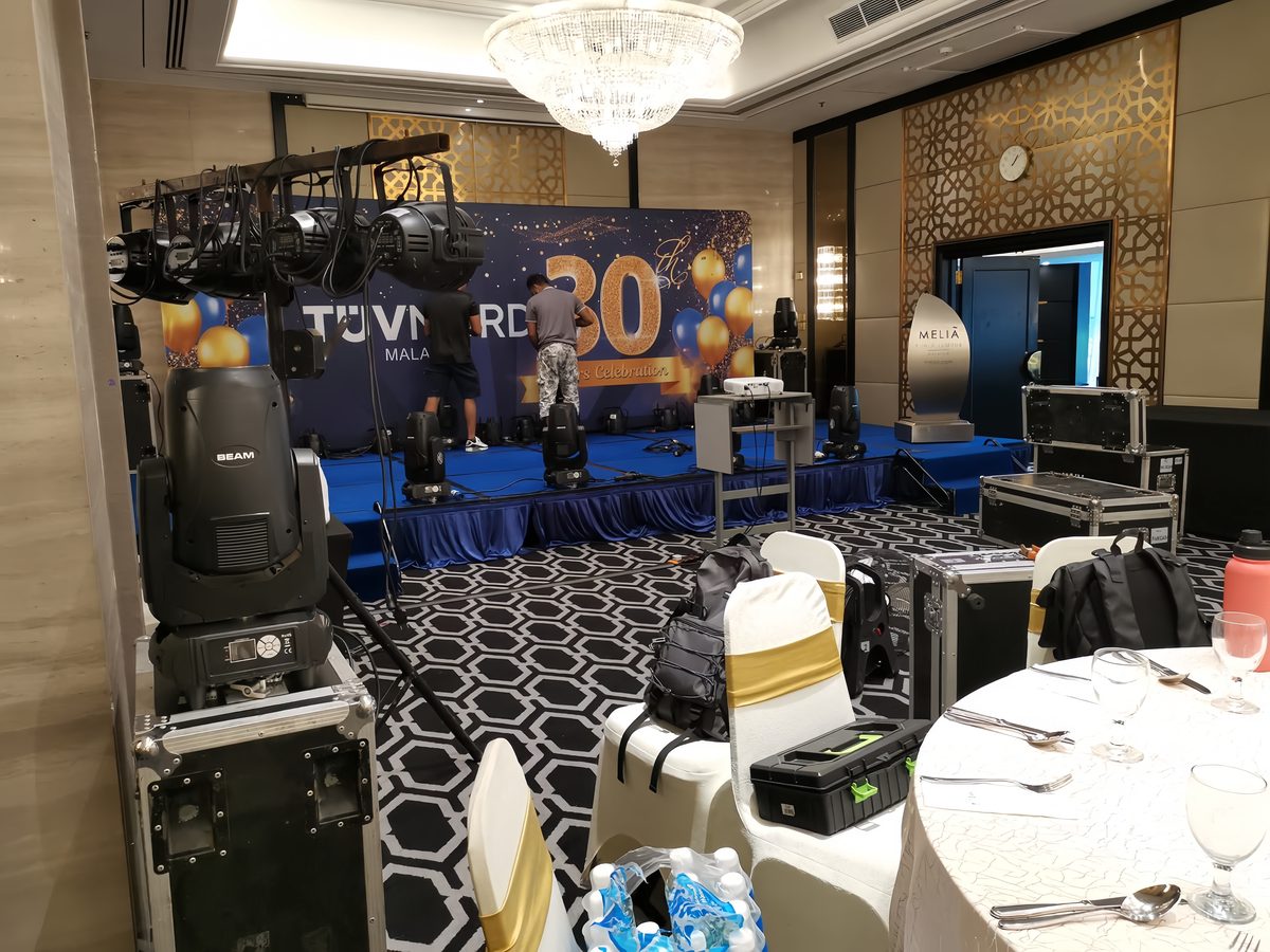 Moving-head lights and truss rig being built for a corporate anniversary dinner