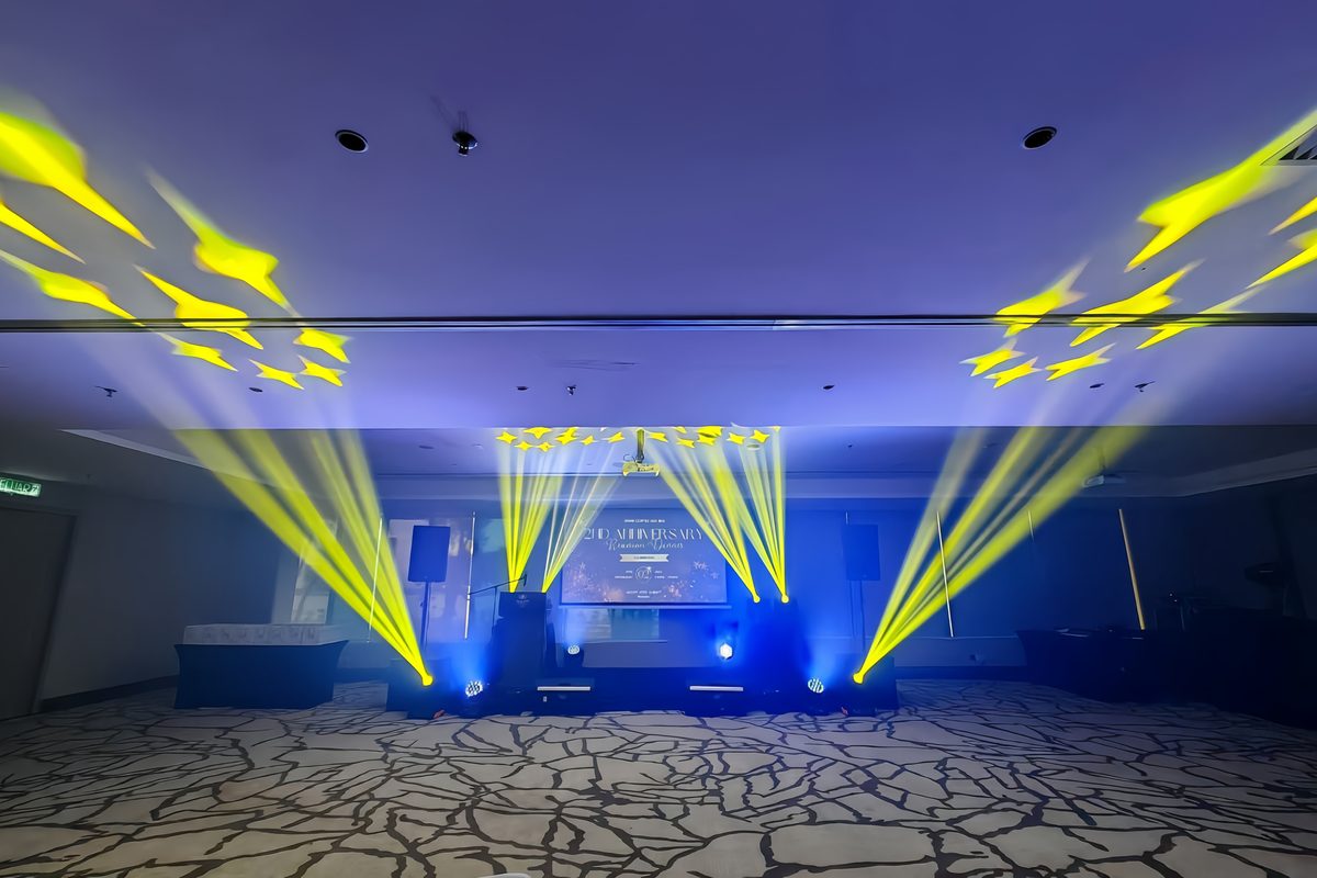 Yellow beams fanned across a hotel ballroom ceiling