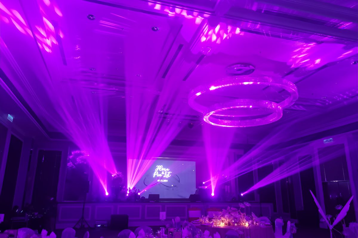Purple wash filling a chandelier ballroom