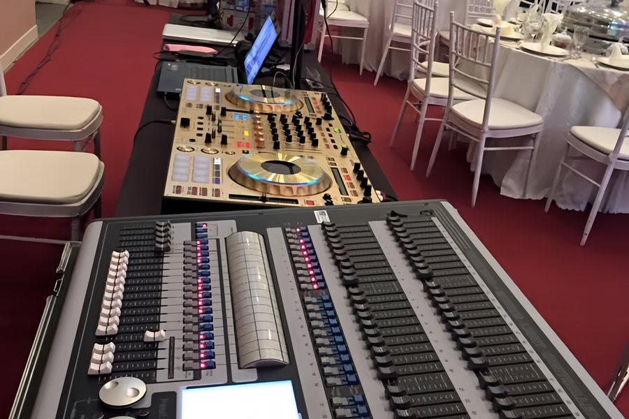 Lighting console and gold DJ controller at a wedding reception