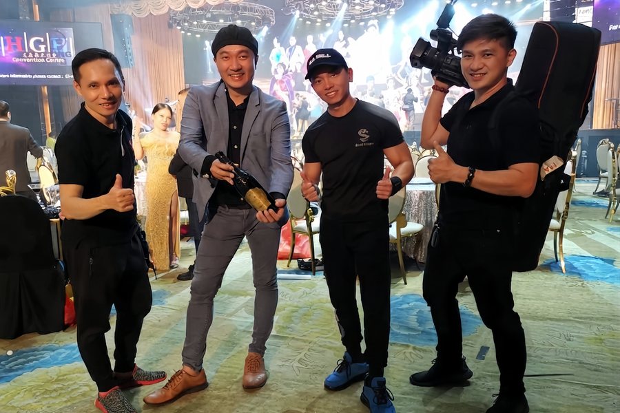 Camera crew backstage with performers before the show