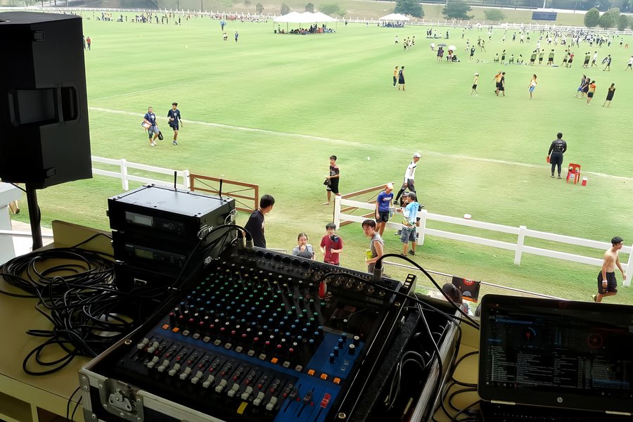 Front-of-house mixing desk set up overlooking a polo field