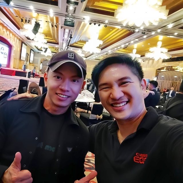 Two crew members in a ballroom during an event
