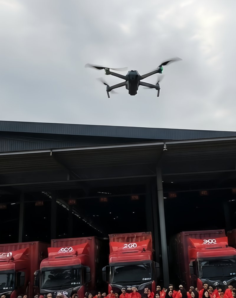 Drone filming overhead as a company assembles its fleet and staff below