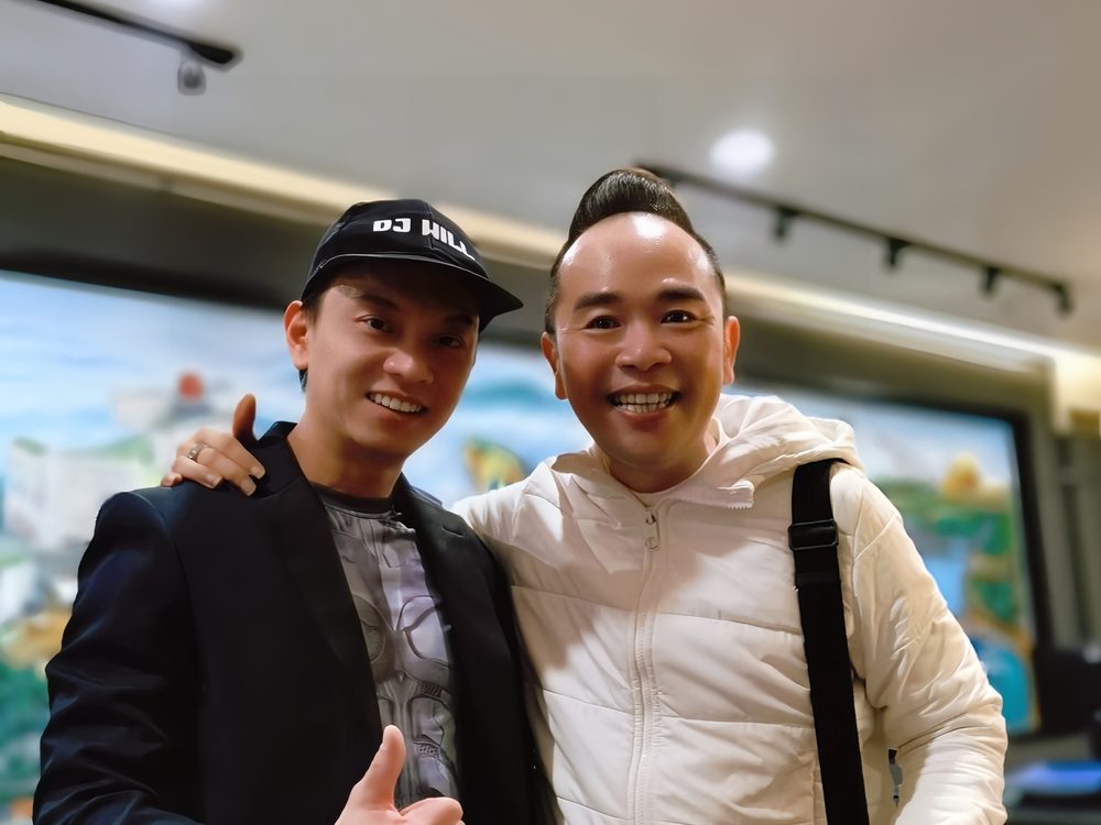 William with a smiling client after a show