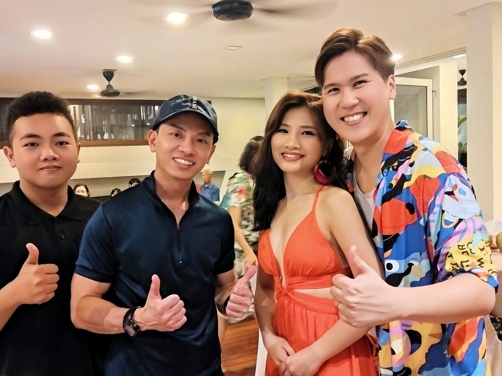 William with party hosts, everyone giving thumbs up