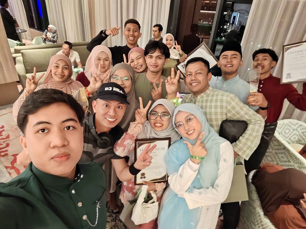 Group selfie with guests holding certificates after an event