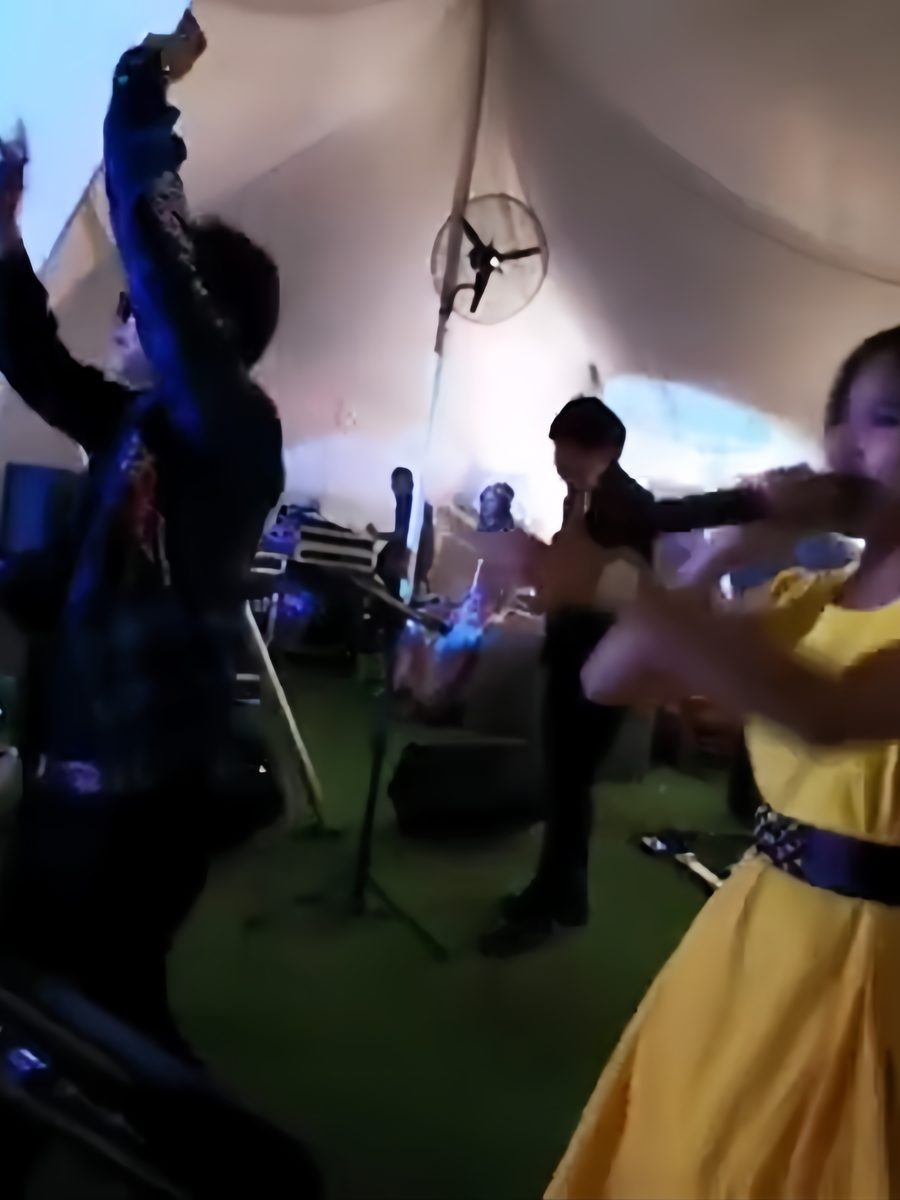 Violinist fronting the band at an outdoor set