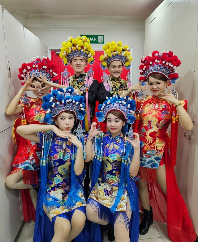 Opera dancers in blue and red embroidered costume
