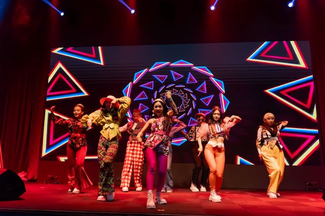 Colourful stage routine under beam lighting