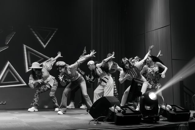 Monochrome shot of the company mid-routine