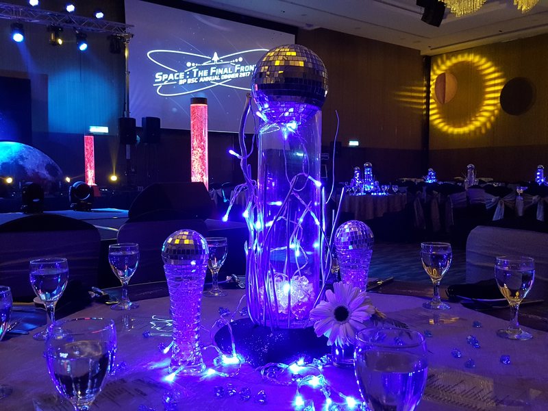 Mirror-ball table centrepiece under blue uplighting