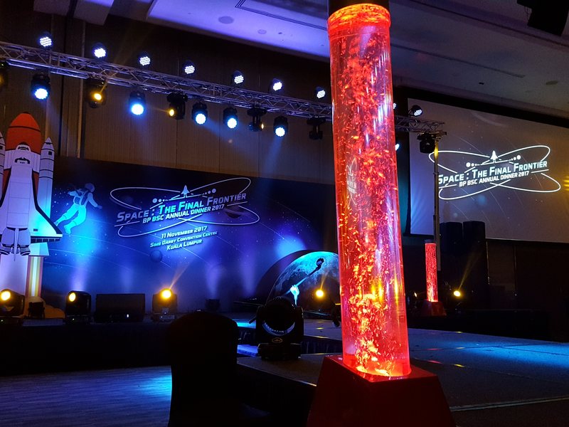 Themed annual-dinner stage with a shuttle prop and bubble columns