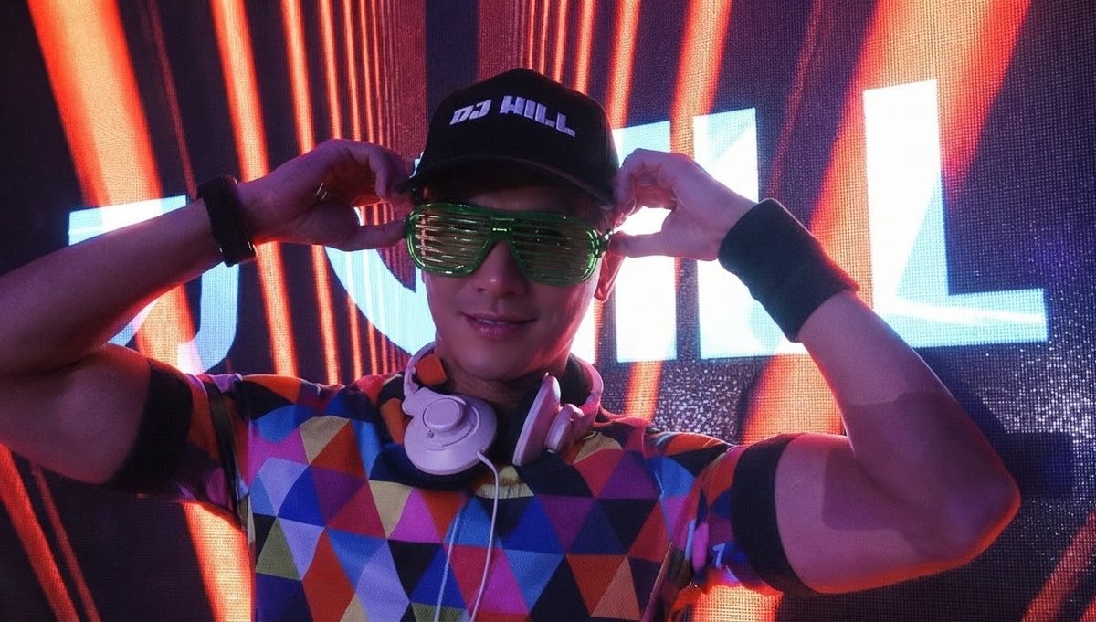 DJ Will in LED shades and a DJ WILL cap in front of an LED wall