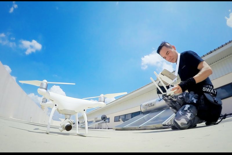 Drone lifting off from a rooftop under clear sky