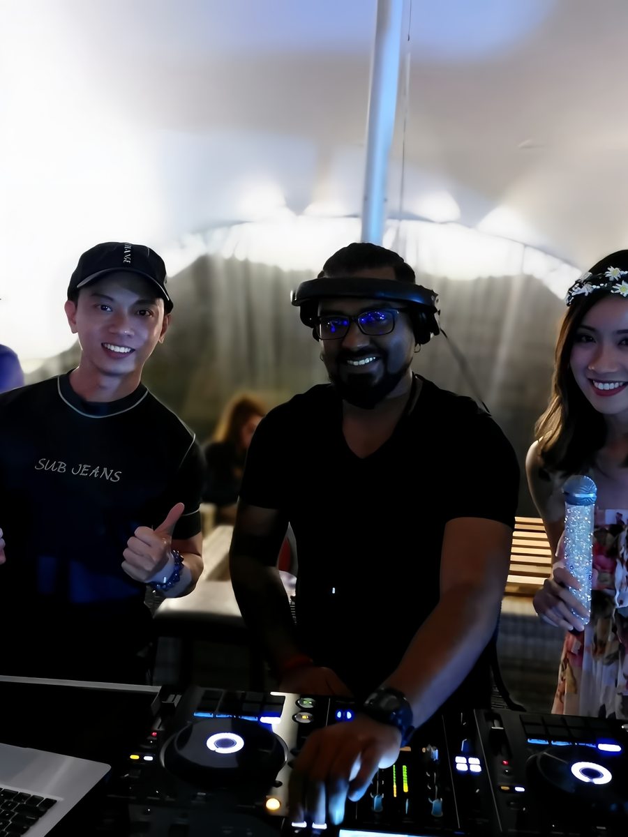 Hosts and crew gathered behind the decks at a marquee event