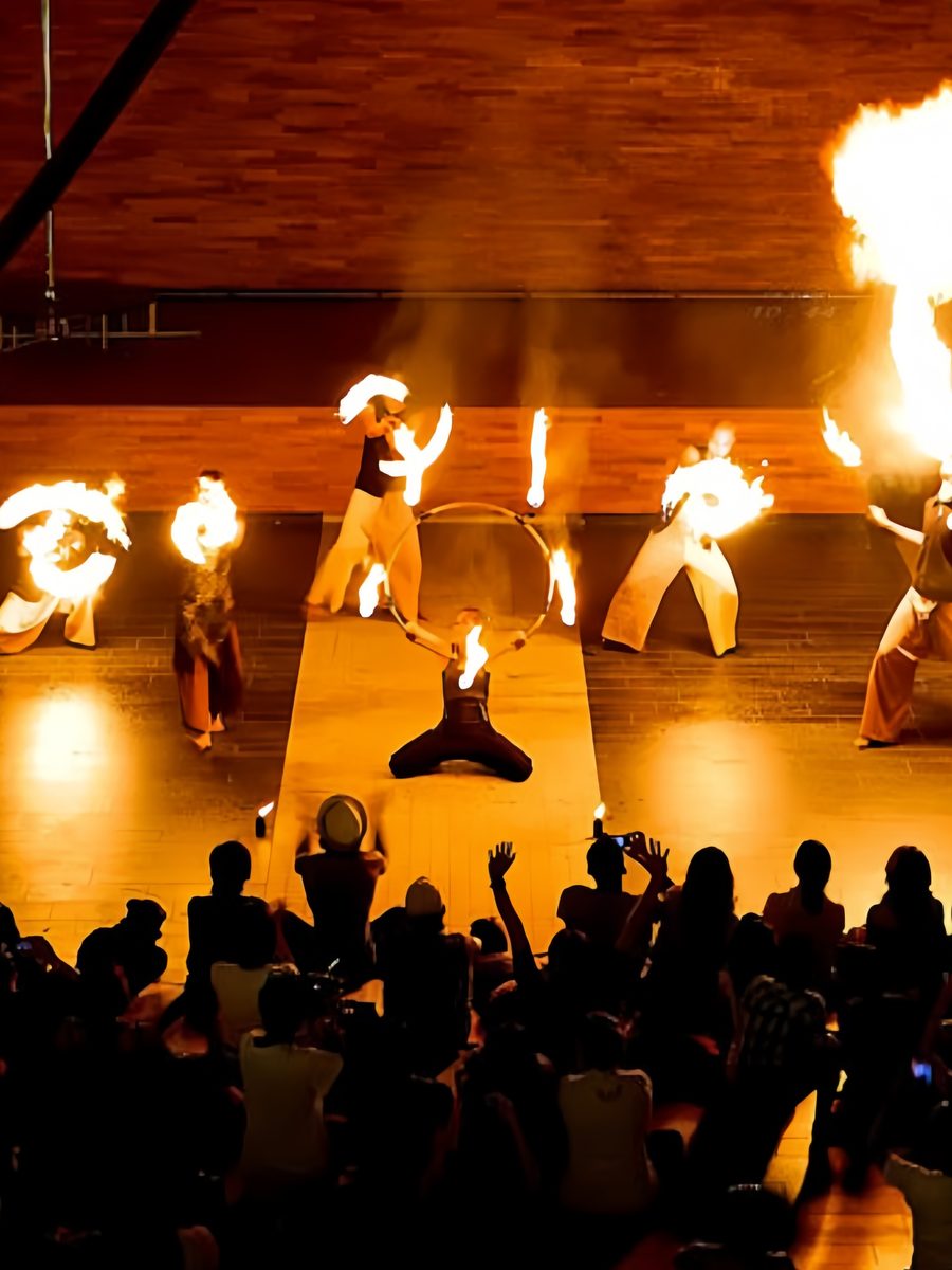 Fire performers spinning flames for a crowd