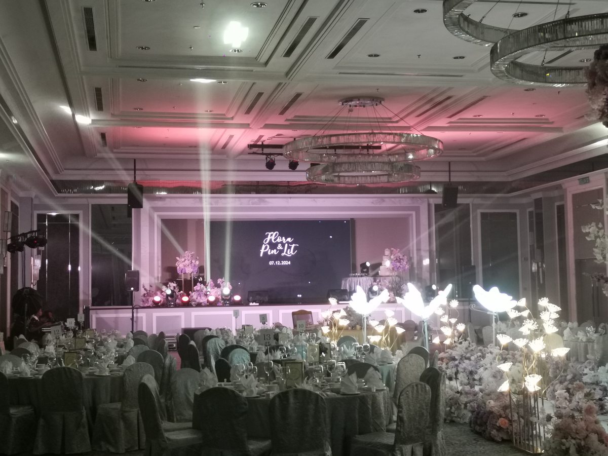 Ballroom dressed in florals under pink and violet light