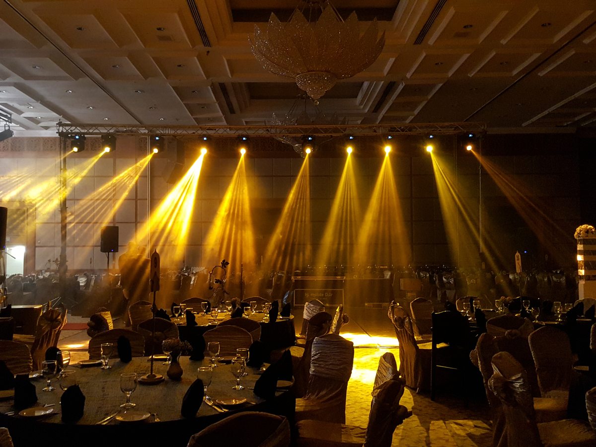 Ballroom washed in warm uplighting before doors open