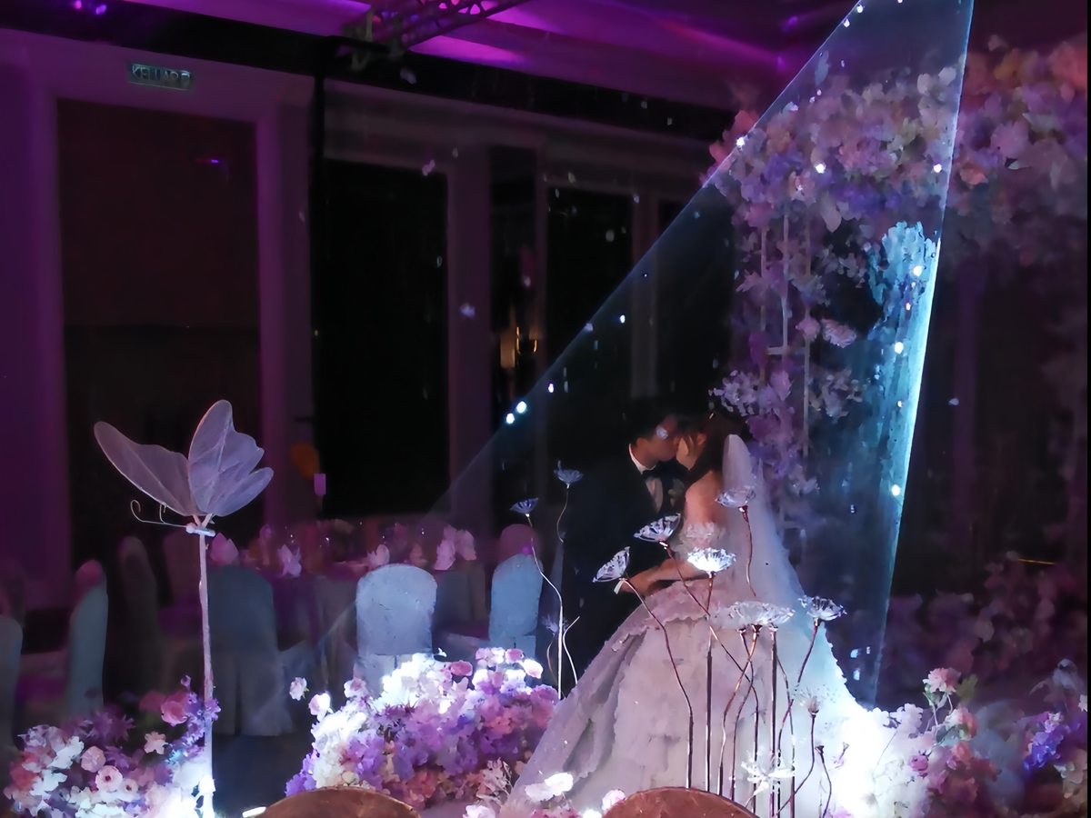 Bride at the floral installation under violet light